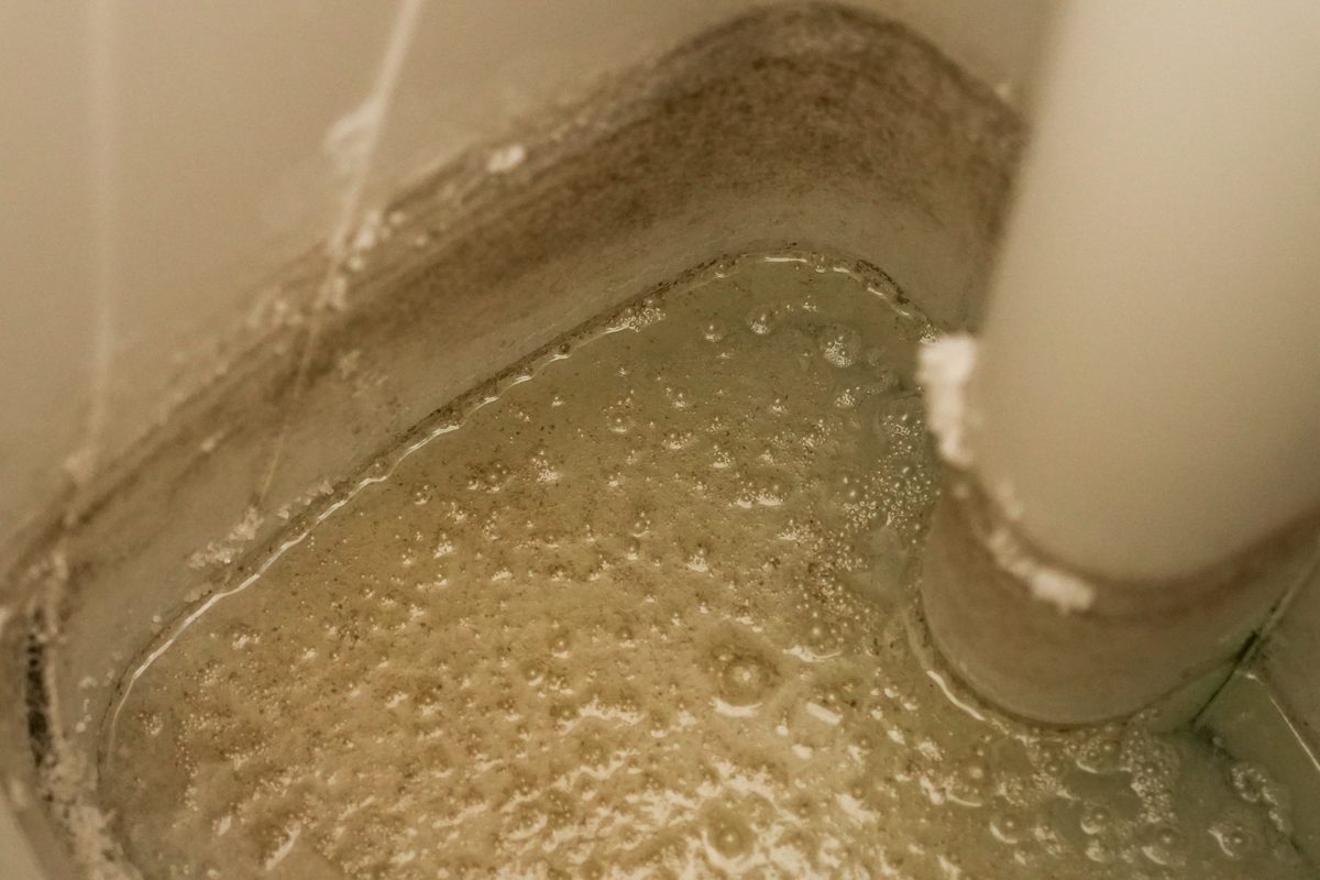 Mineral and sediment buildup found inside a neglected brine tank