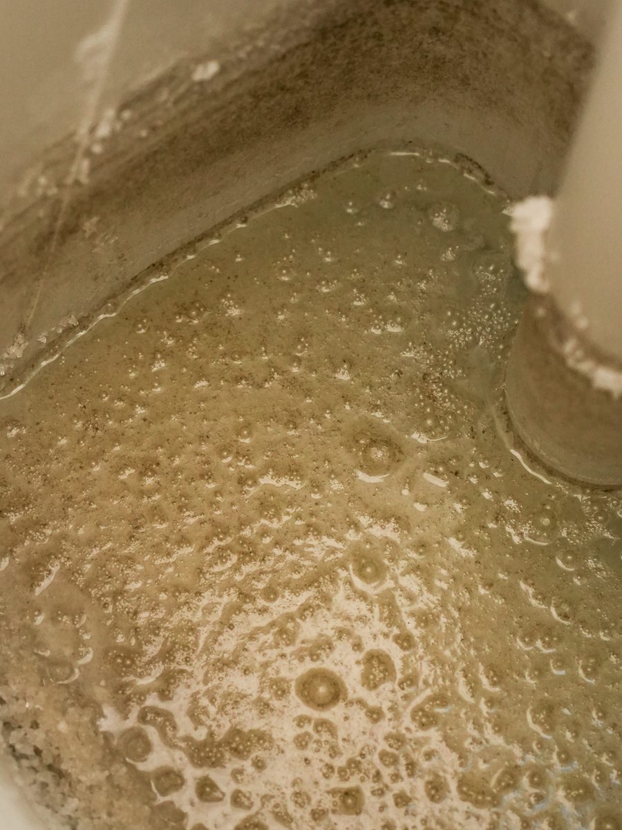 Scale and sediment found inside a brine tank before a service visit