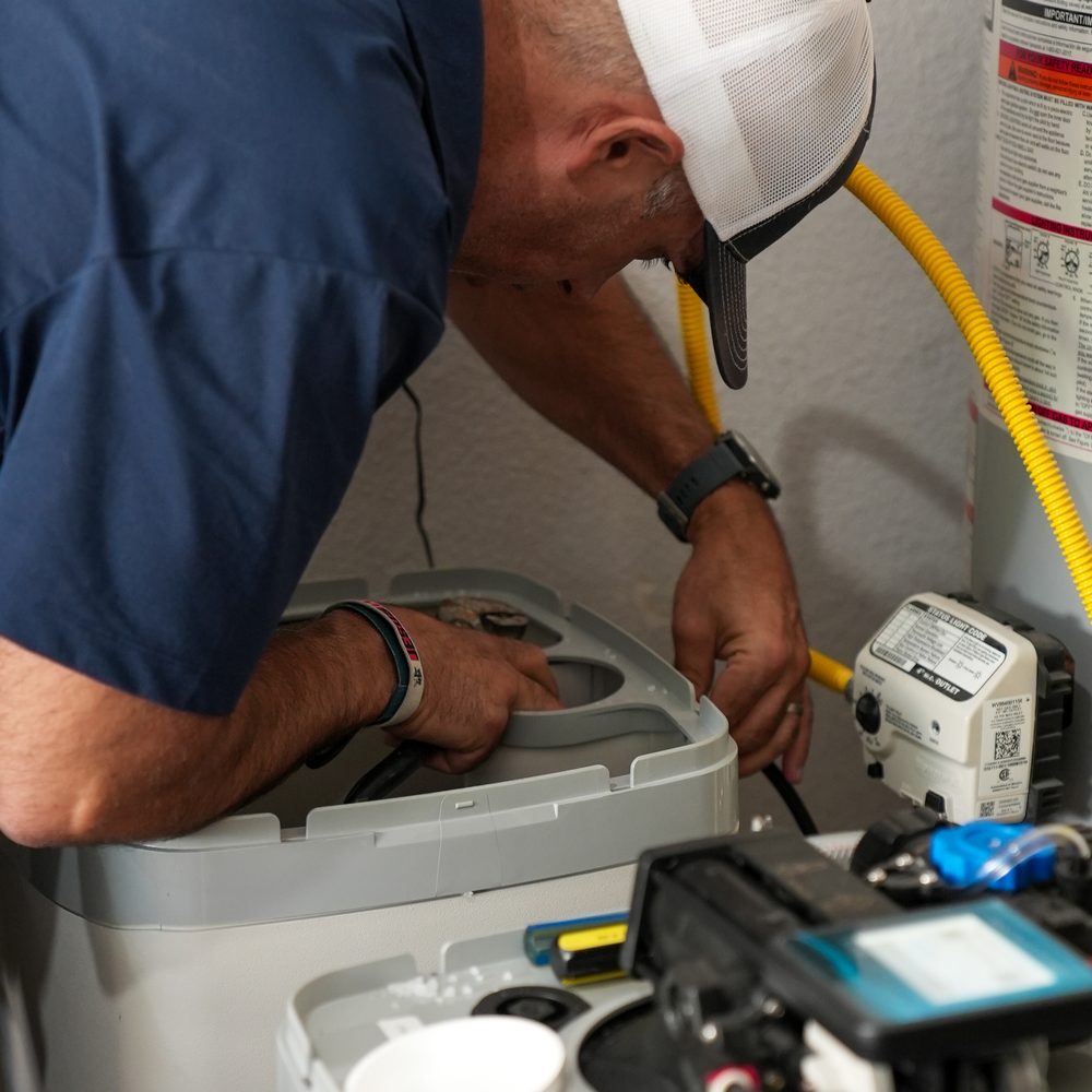 A Treasure Valley Water Solutions technician servicing a water softener